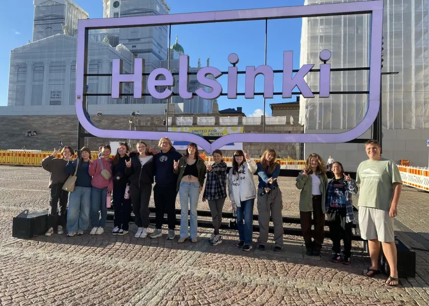 group of NDSU first-year students in Finland posing under a Helsinki sign