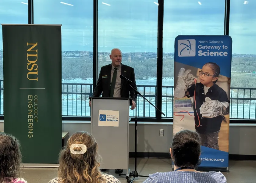 Alan Kallmeyer, NDSU dean of the College of Engineering stands behind a podium while talking to an audience.