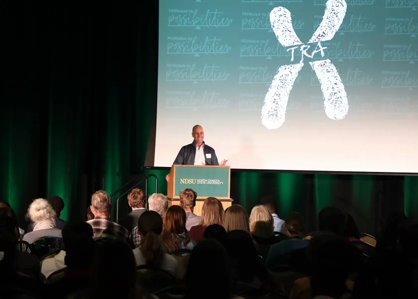 A presenter speaks on a stage at the annual Possibility Showcase event.