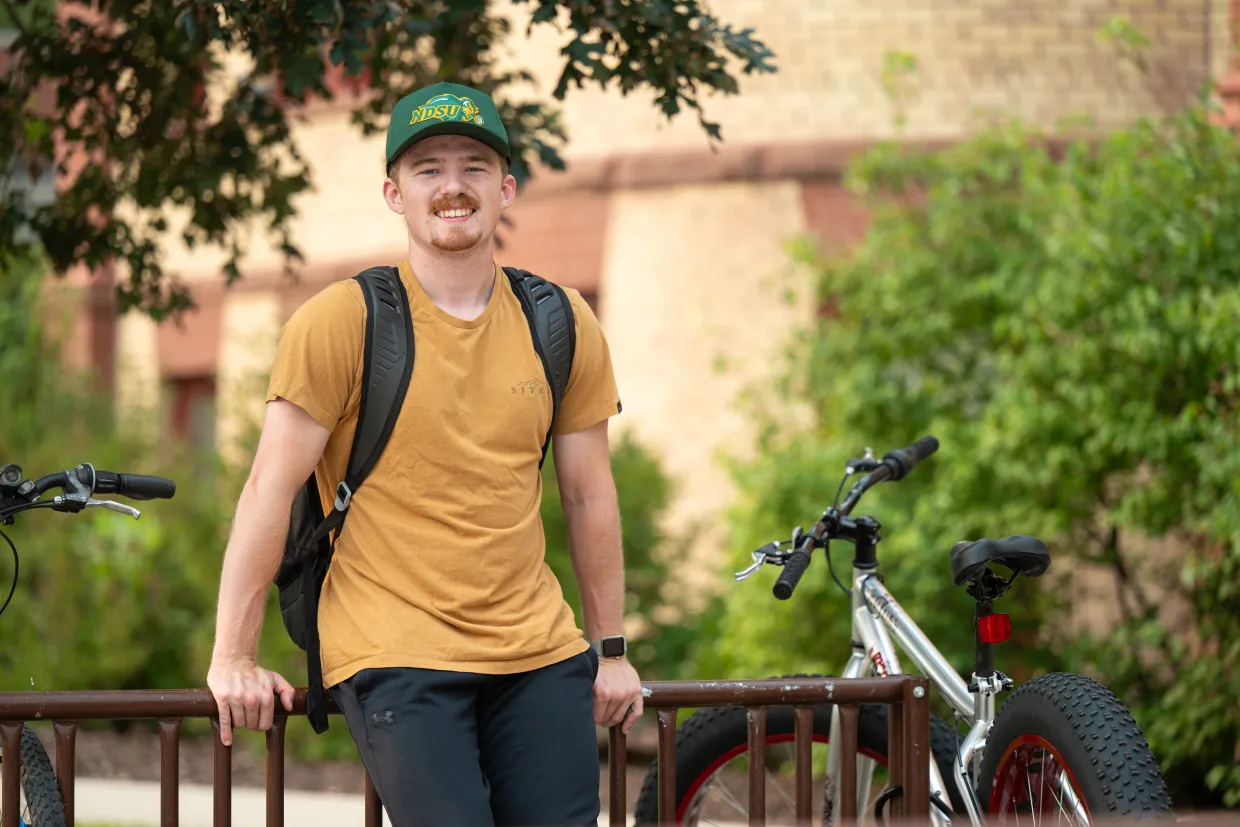Student sitting on bike rack
