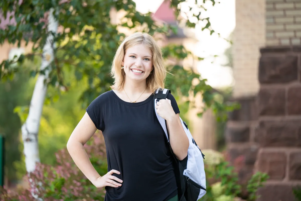 Student standing with backpack