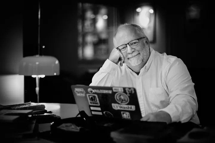 John Cox, NDSU professor of history, sits in front of his laptop.