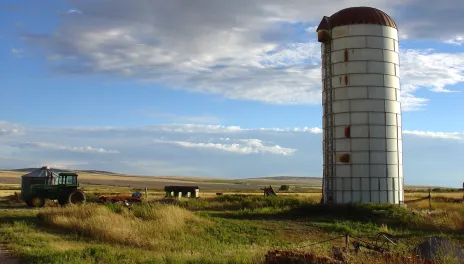 Old silo and farm with a blue sky