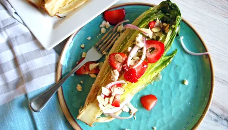 Grilled Romaine Salad on a blue plate with fork