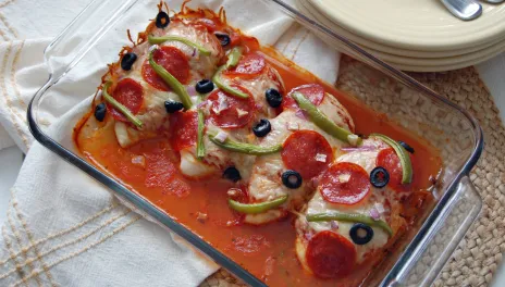 Supreme Pizza Chicken Bake in a glass pan on a counter top