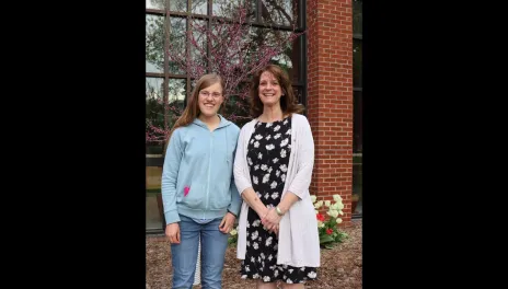 Elizabeth Krause and Dr. Thompson stand in front of Loftsgard Hall