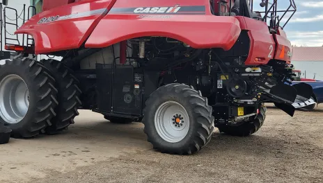 A large black mechanism has been added to the back of a Case IH 8120 combine.