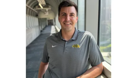 Man poses for a photo in a skyway