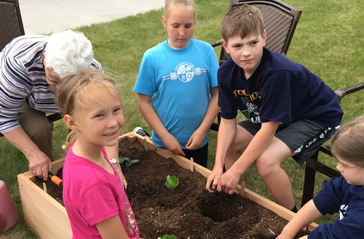 youth and volunteer planting garden