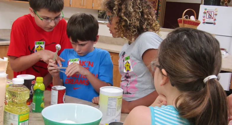 small group of kids cooking