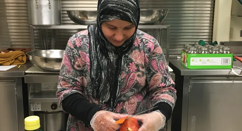 woman slicing tomato