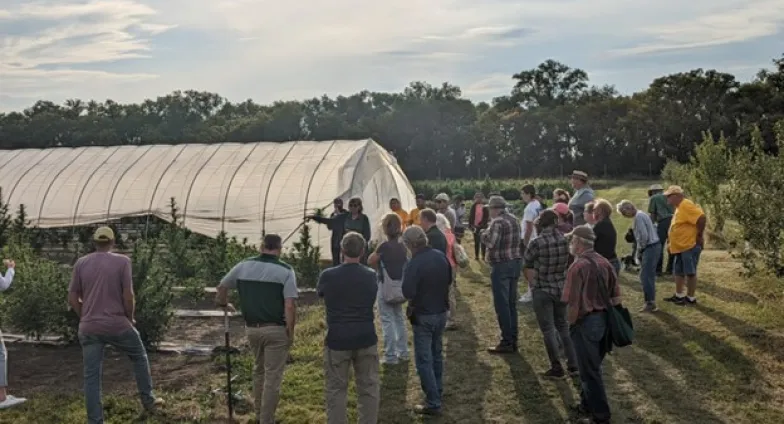 People having a discussion outside a greenhouse