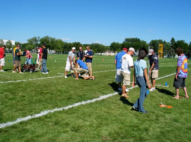 examining turf on a sports field