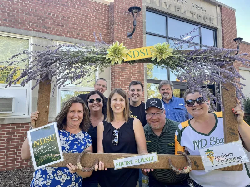 Animal Sciences Department staff posing in a decorative frame