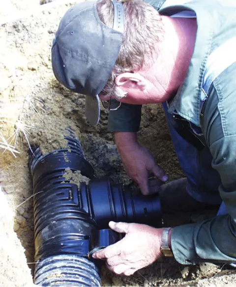 Man installing drainage.