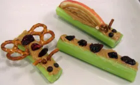 celery, pretzels, peanut butter, mini chocolate chips, craisins, raisins, apple slices