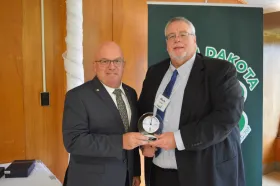 Mark Landa presents an award to Bob Finken 