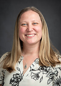 Professional photo of Dr. Finley in a black and white blouse