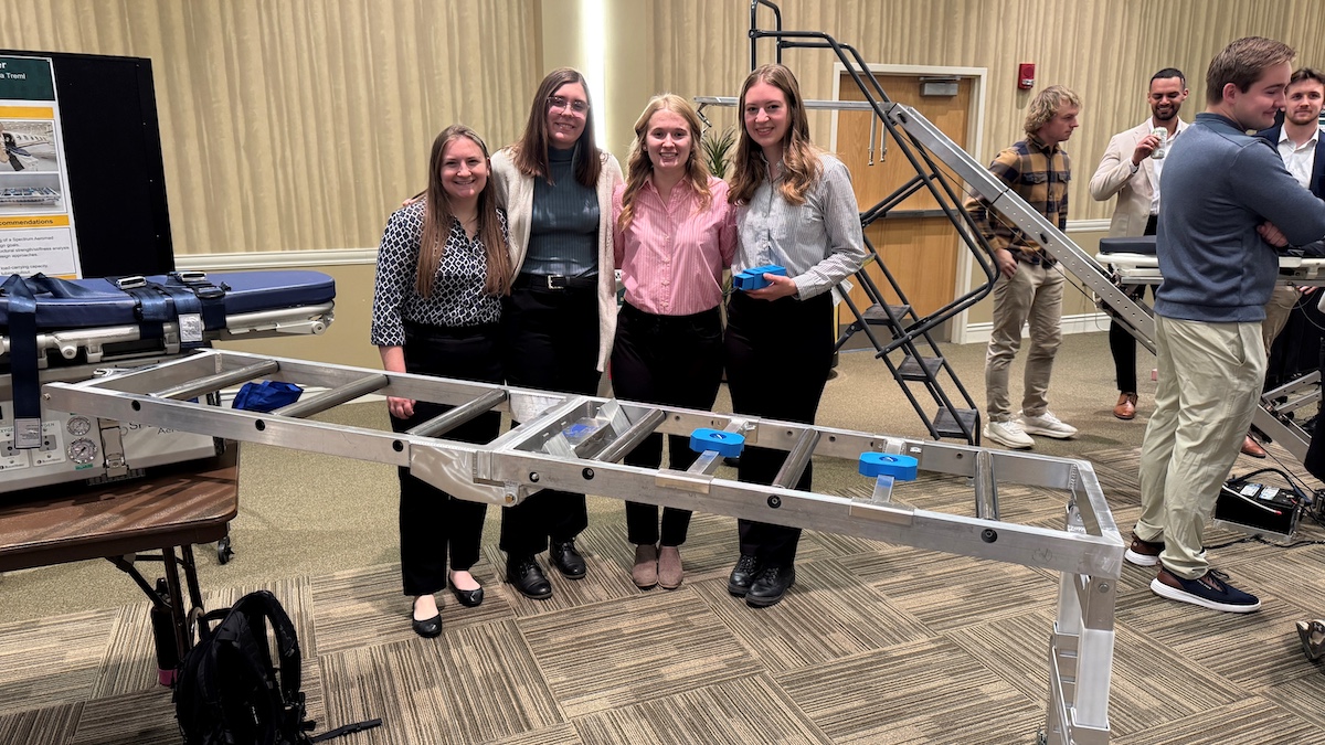 Engineering students working on loader prototype