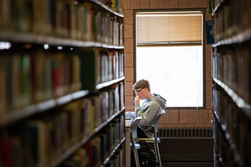 A student sits in the NDSU Main Library to study.