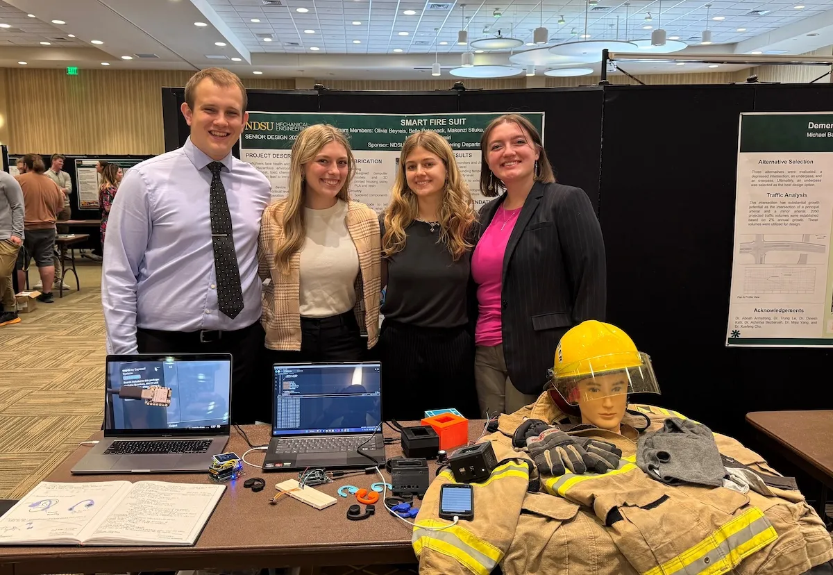 NDSU engineering students Olivia Beyreis, Belle Petronack, Makenzi Stluka and Corby Svihovec stand by their project poster
