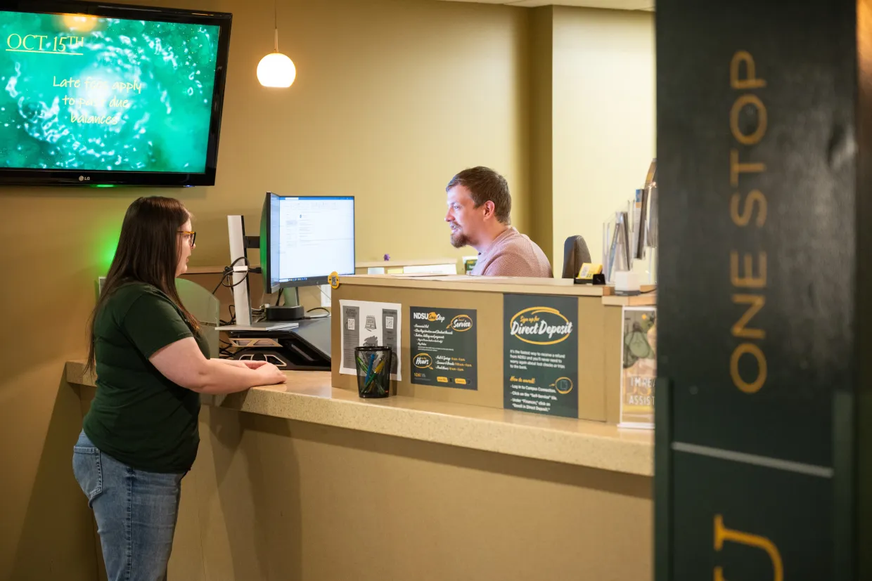 An NDSU student stands at the One Stop counter located in the Memorial Union.
