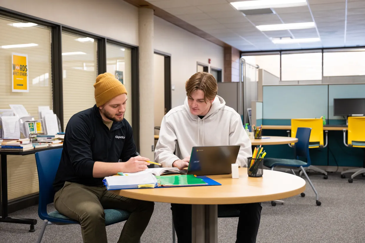 Two NDSU students work on a laptop in the Center for Writers.